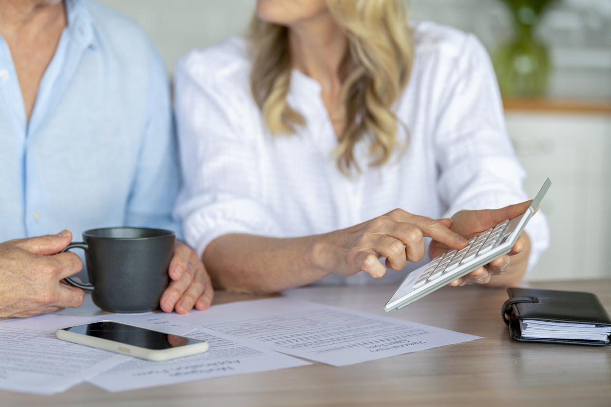 A couple trying to reduce studying their finances to debt