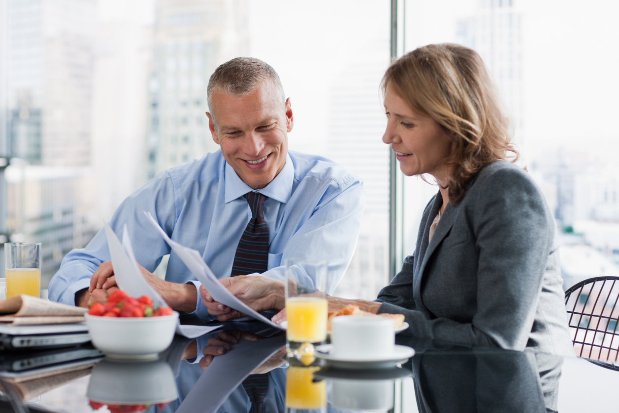 Middle-aged couple in the Hunter Region reviewing their superannuation and retirement plan on a laptop at home